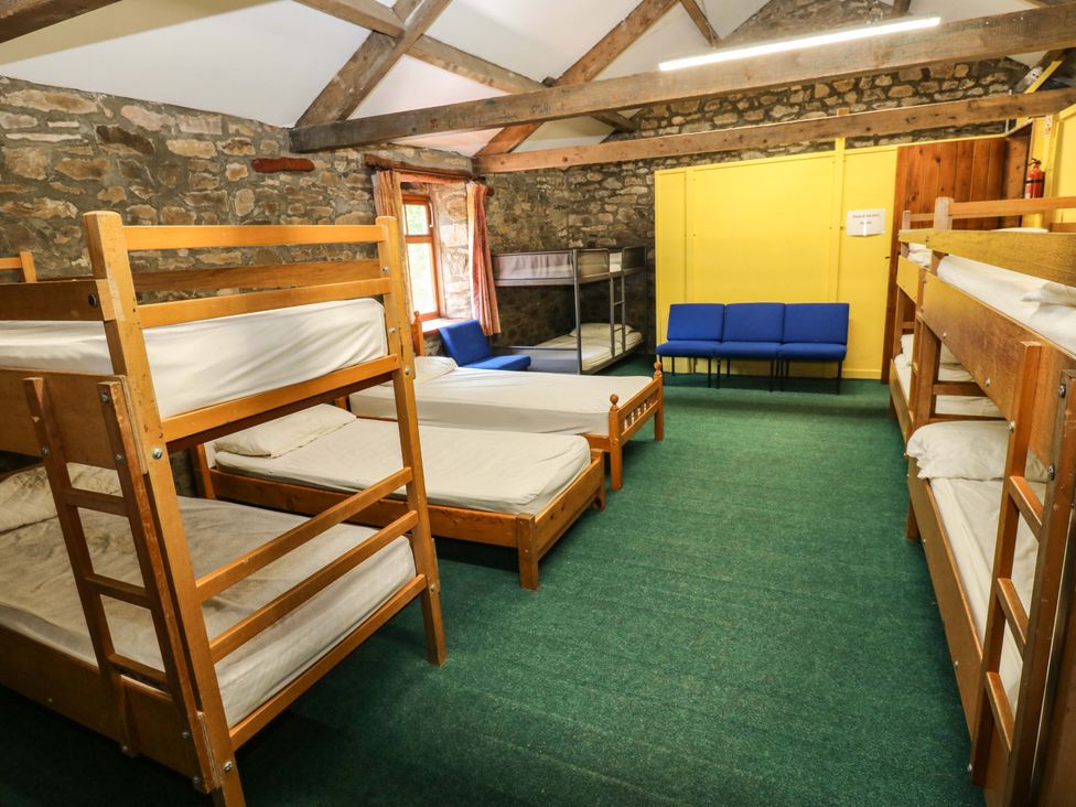 A bedroom with bunk beds and seating at West Barn 