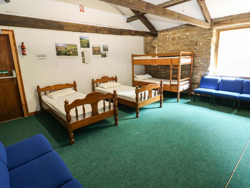 A bedroom with bunk beds and single beds at West Barn