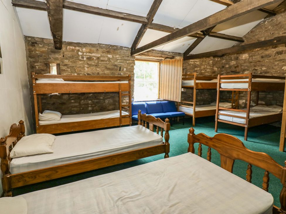 A bedroom with bunk beds and a sofa at West Barn