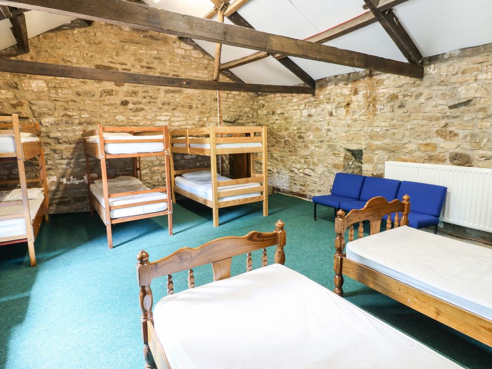 A bedroom with bunk beds and a sofa at West Barn