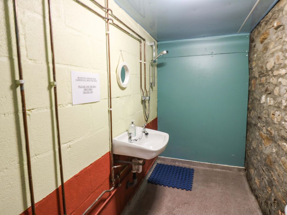 A bathroom with a sink and shower at West Barn