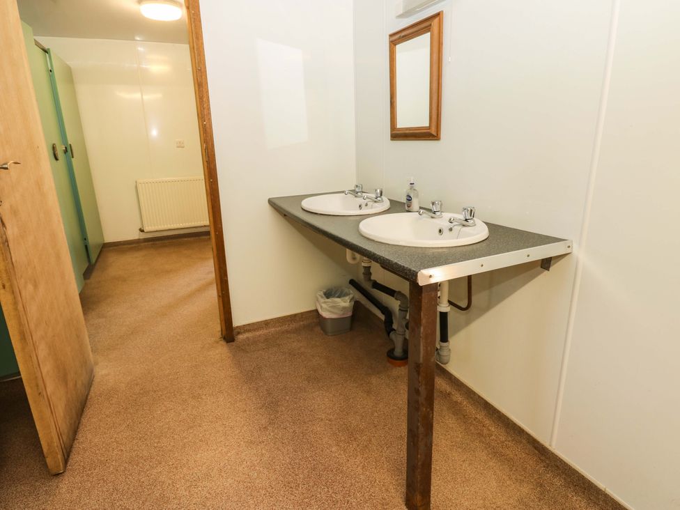A bathroom with two sinks and a mirror at West Barn 