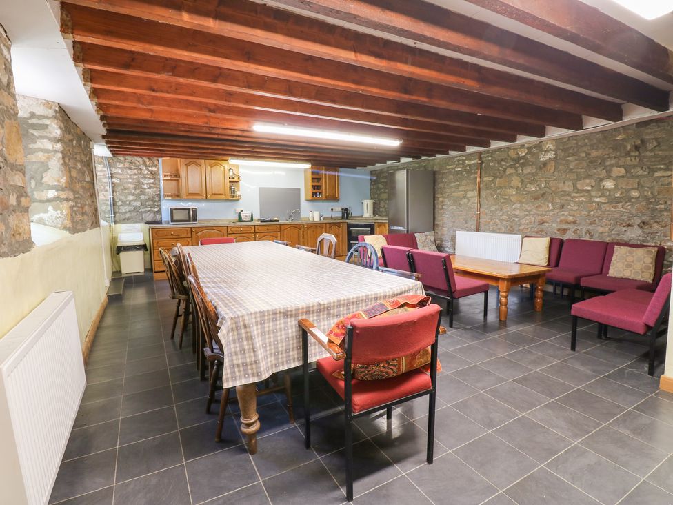 A dining room with a large table and chairs at East Barn Bunkhouse