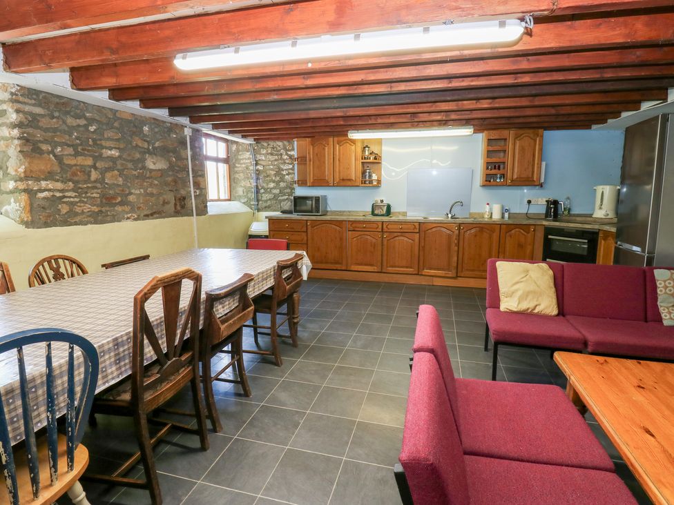 A kitchen with a dining area and seating space at East Barn Bunkhouse