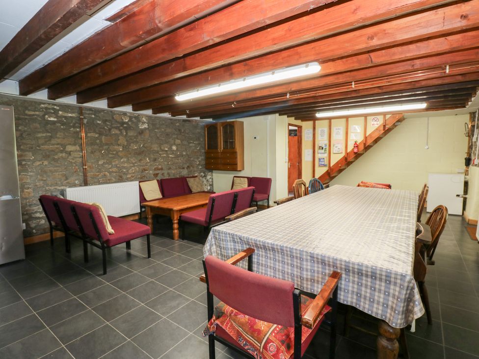 A dining room with a table and chairs at East Barn Bunkhouse