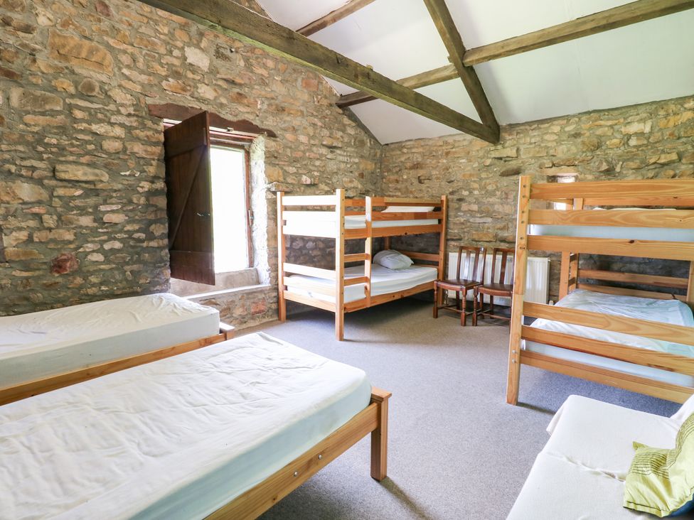 A bedroom with bunk beds and a window at East Barn Bunkhouse