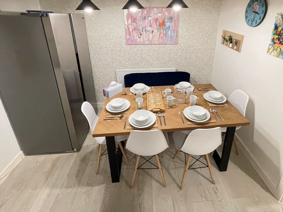 A dining room with a table set for a meal at Derby Den in Breadsall near Derby