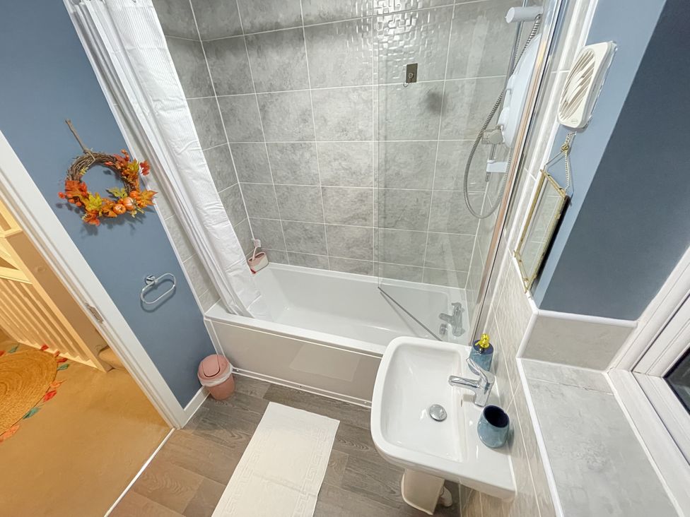 A bathroom with a shower and a sink at Derby Den in Breadsall near Derby