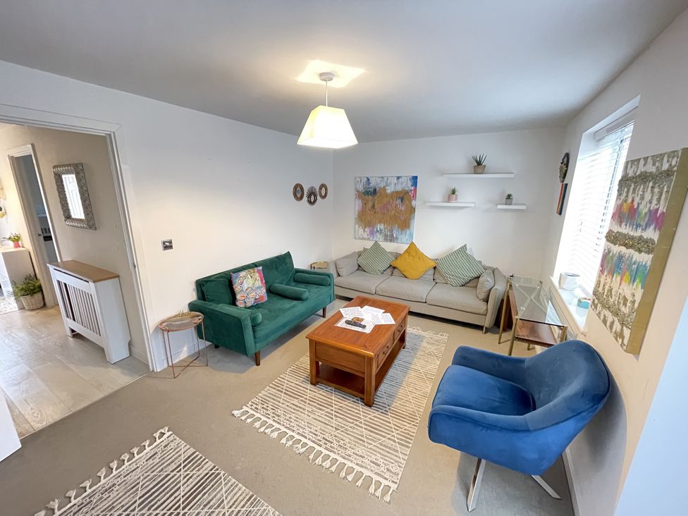 A living room with a coffee table and armchairs at Derby Den in Breadsall near Derby