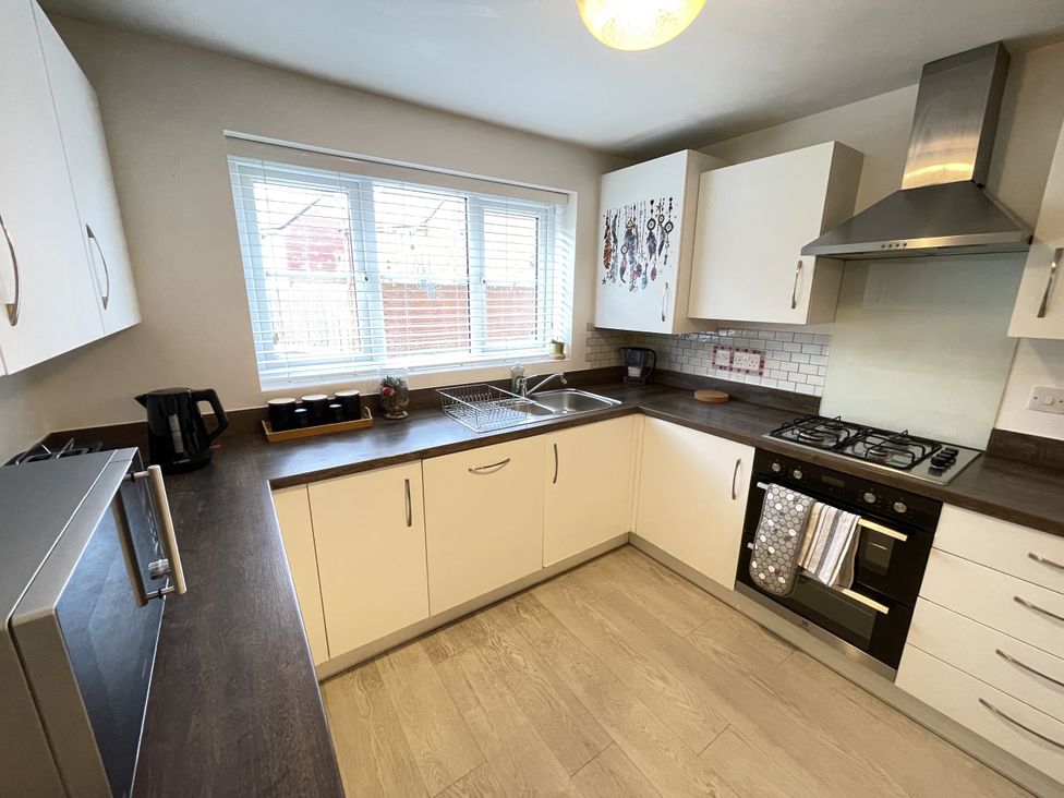 A kitchen with a sink and cooking range at Derby Den Breadsall near Derby