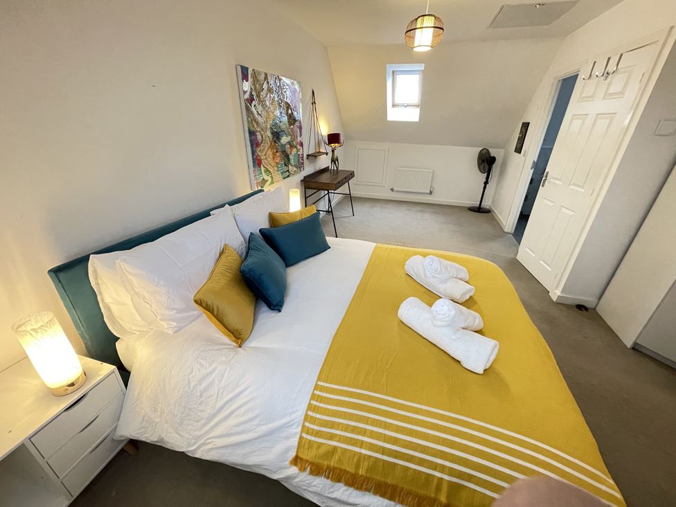 A bedroom with a bed and desk at Derby Den Breadsall near Derby