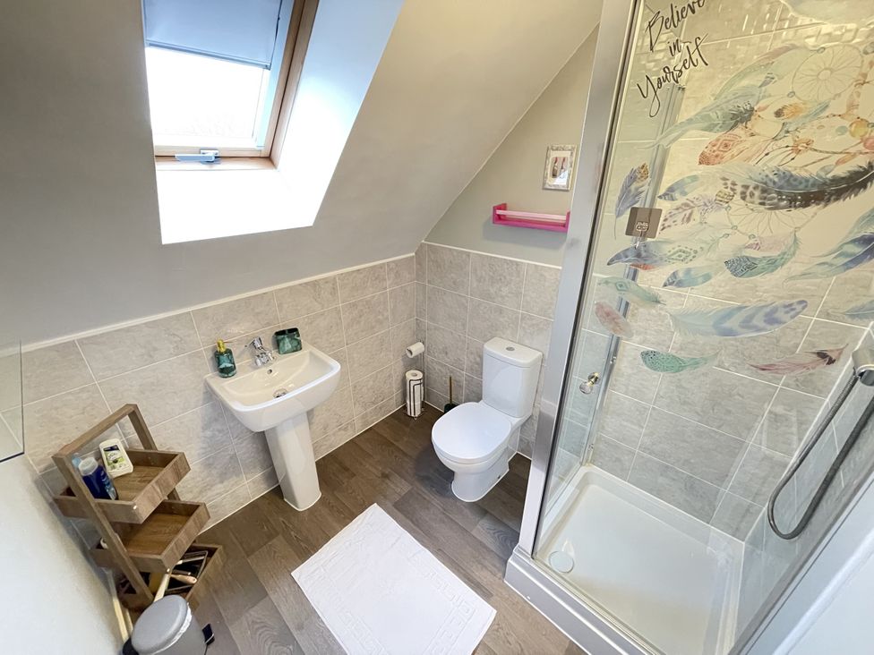 A bathroom with a sink and shower at Derby Den in Breadsall near Derby