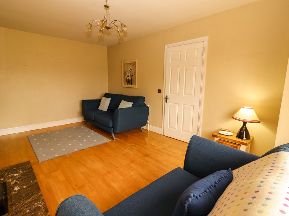 A living room with a sofa and a lamp at 51 Woodview Park Tralee, County Kerry