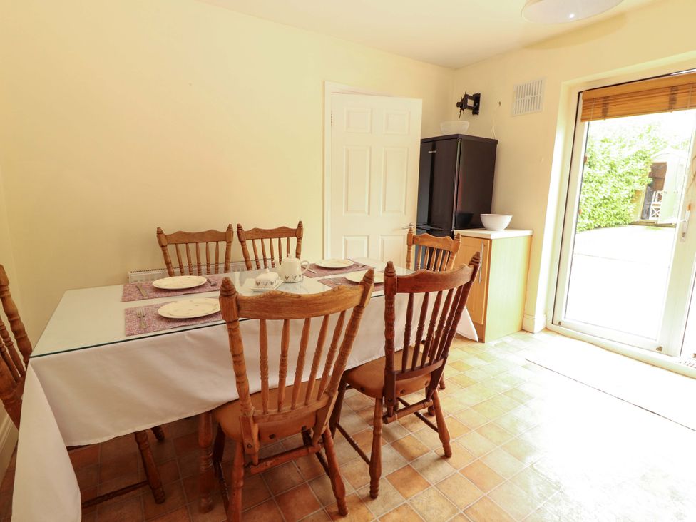 A dining room with a table and chairs at 51 Woodview Park in Tralee, County Kerry