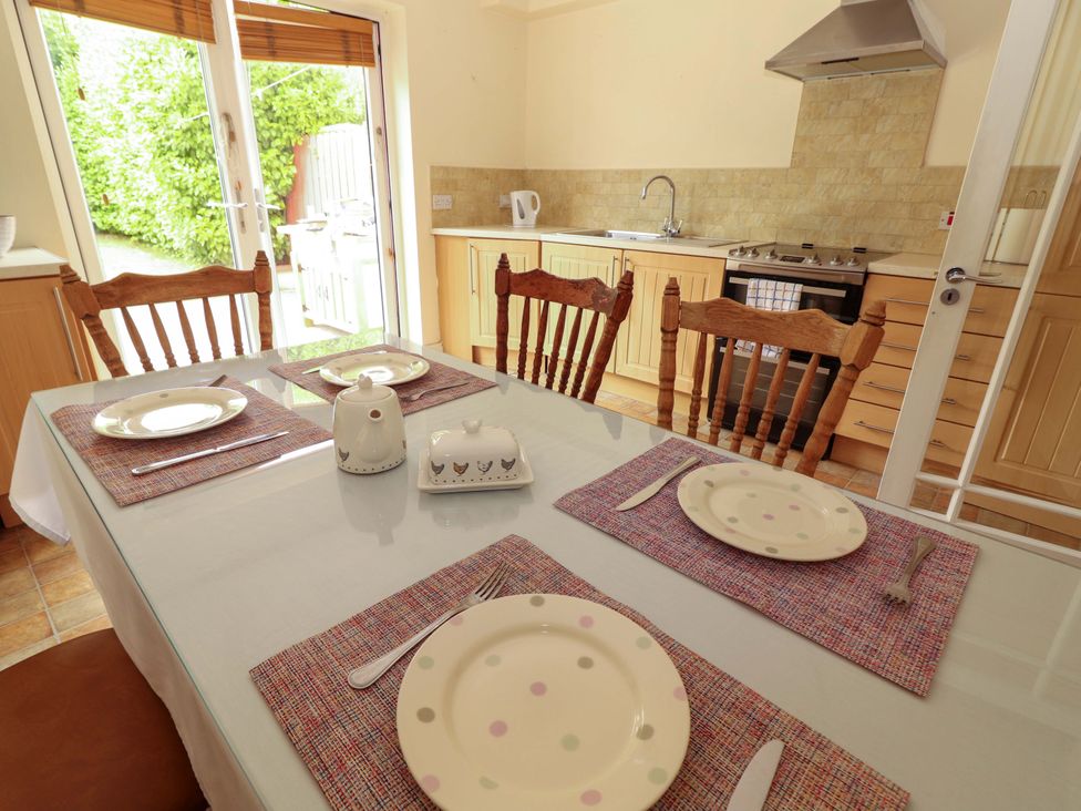 A dining room with a table set for meals at 51 Woodview Park in Tralee, County Kerry