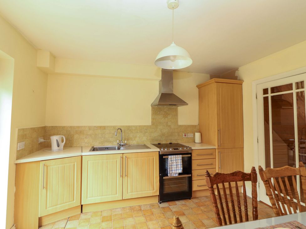 A kitchen with cabinets and appliances at 51 Woodview Park in Tralee, County Kerry