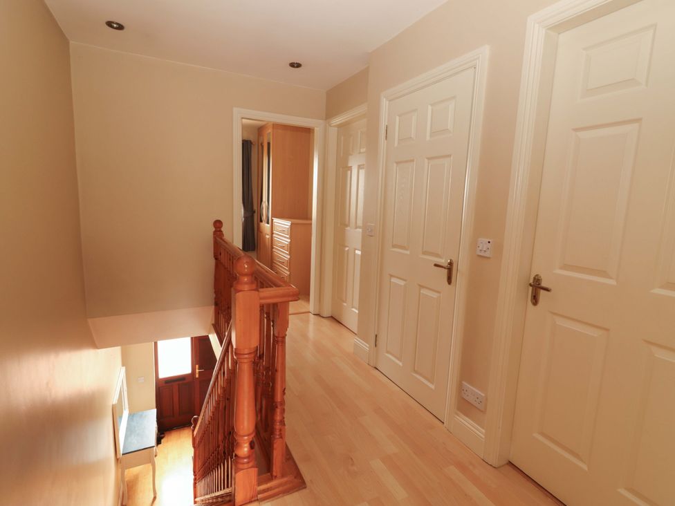 A hallway with a staircase and multiple doors at 51 Woodview Park, Tralee, County Kerry