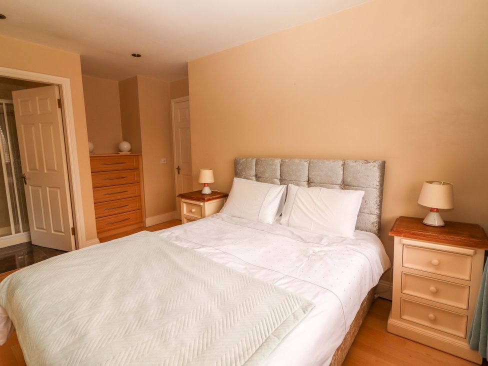 A bedroom with a bed and bedside tables at 51 Woodview Park in Tralee, County Kerry