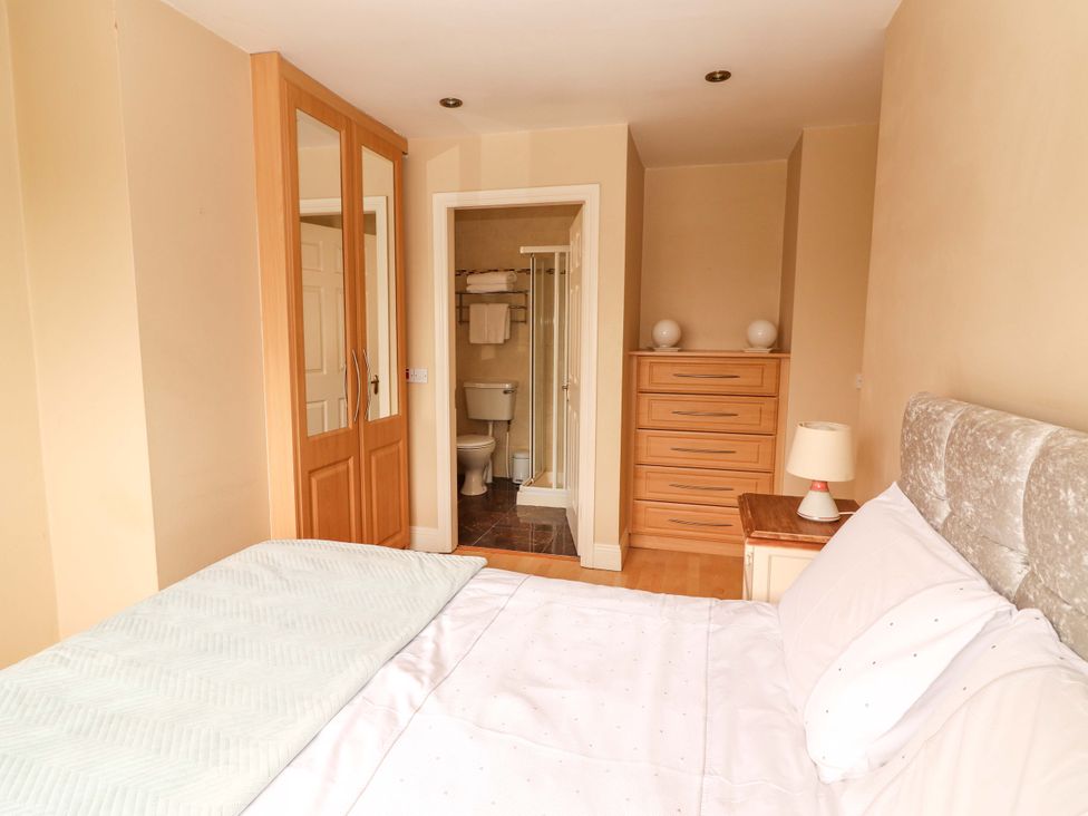A bedroom with a bed and attached bathroom at 51 Woodview Park, Tralee, County Kerry