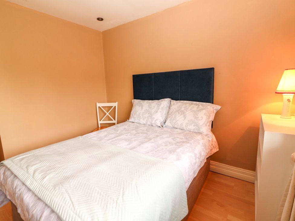 A bedroom with a bed and a chair at 51 Woodview Park in Tralee, County Kerry