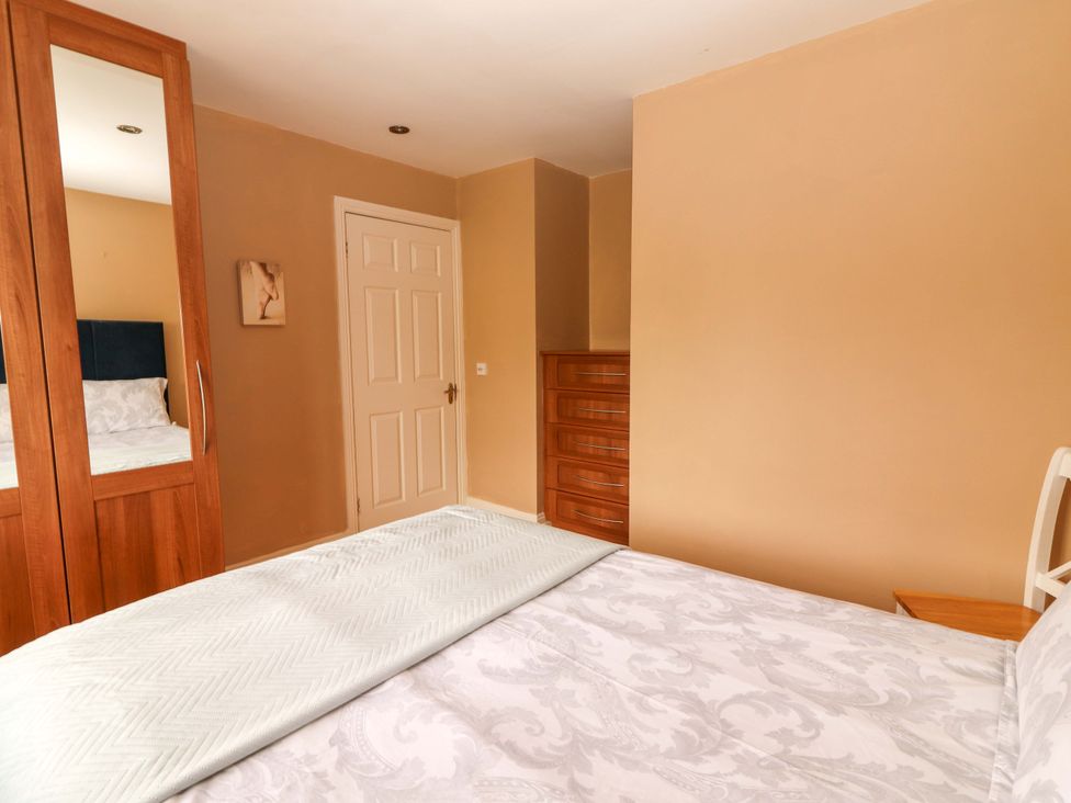 A bedroom with a bed and wardrobe at 51 Woodview Park, Tralee, County Kerry