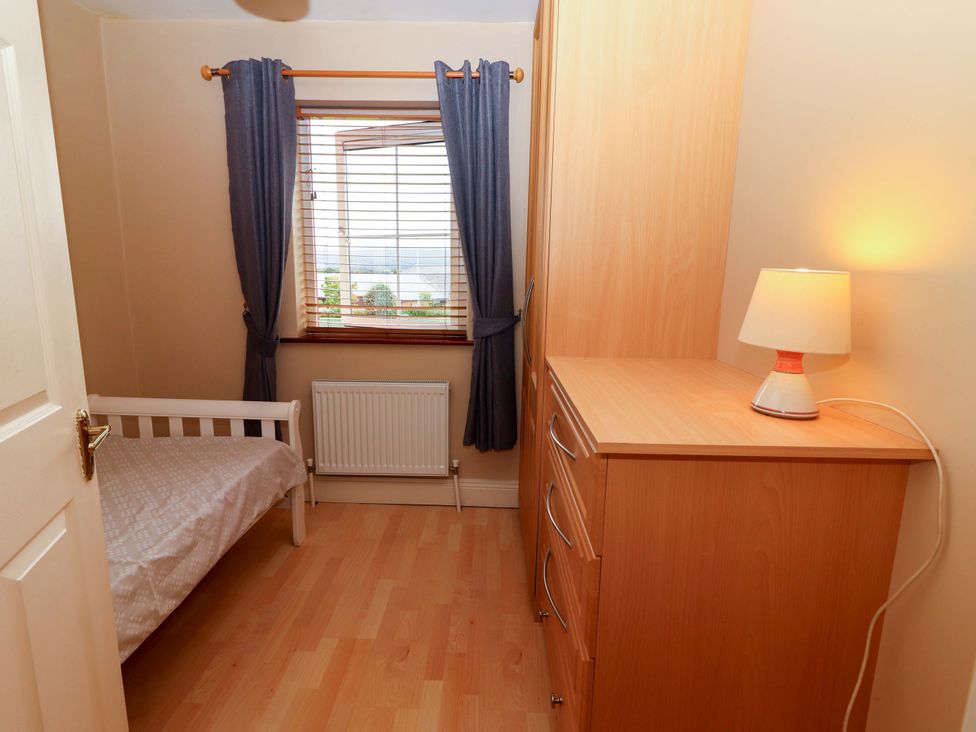 A bedroom with a bed and a window at 51 Woodview Park, Tralee, County Kerry