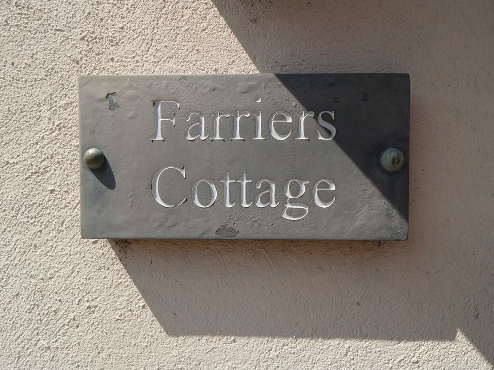 A nameplate for Farriers Cottage