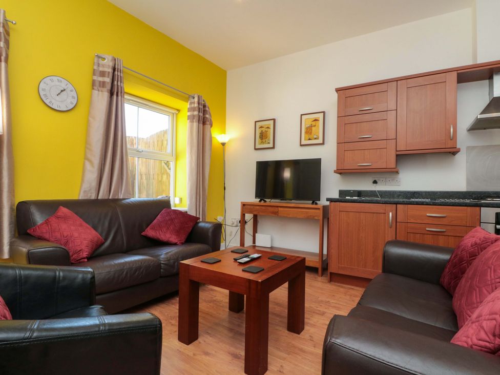 A living room with a sofa and television at Farriers Cottage in Bridlington