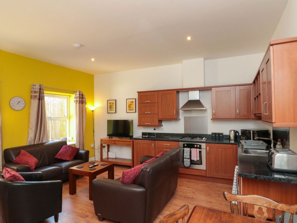 A living room with kitchen area at Farriers Cottage in Bridlington