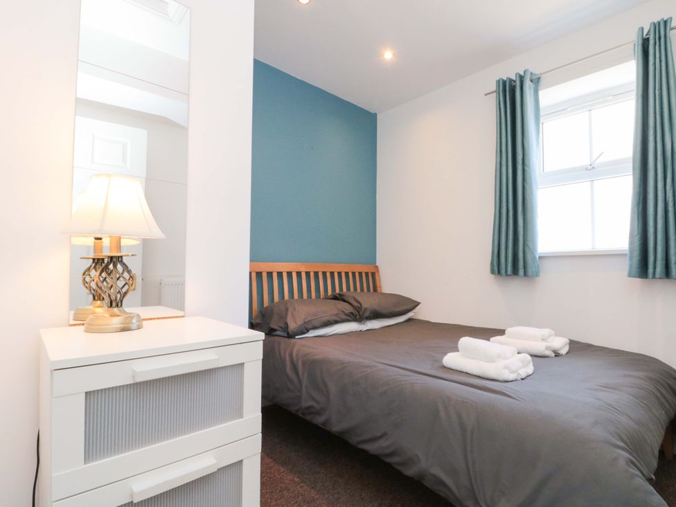 A bedroom with a bed and lamp at Farriers Cottage in Bridlington