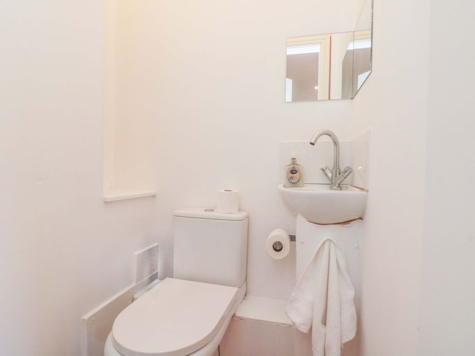 A bathroom with a toilet and sink at Farriers Cottage in Bridlington