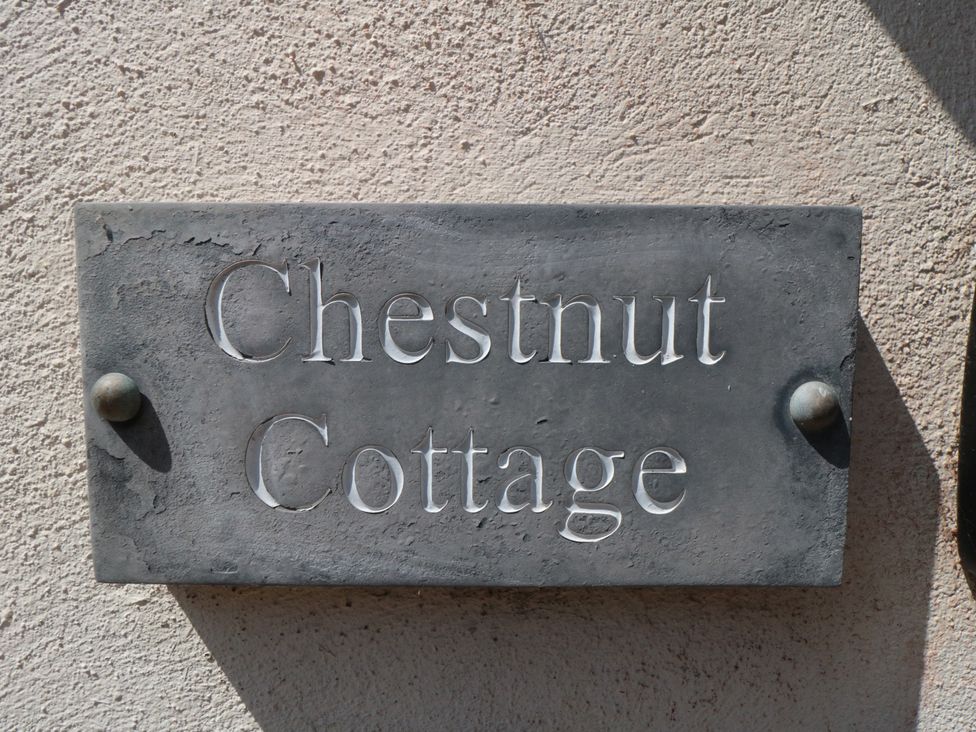 A nameplate on a wall for Chestnut Cottage