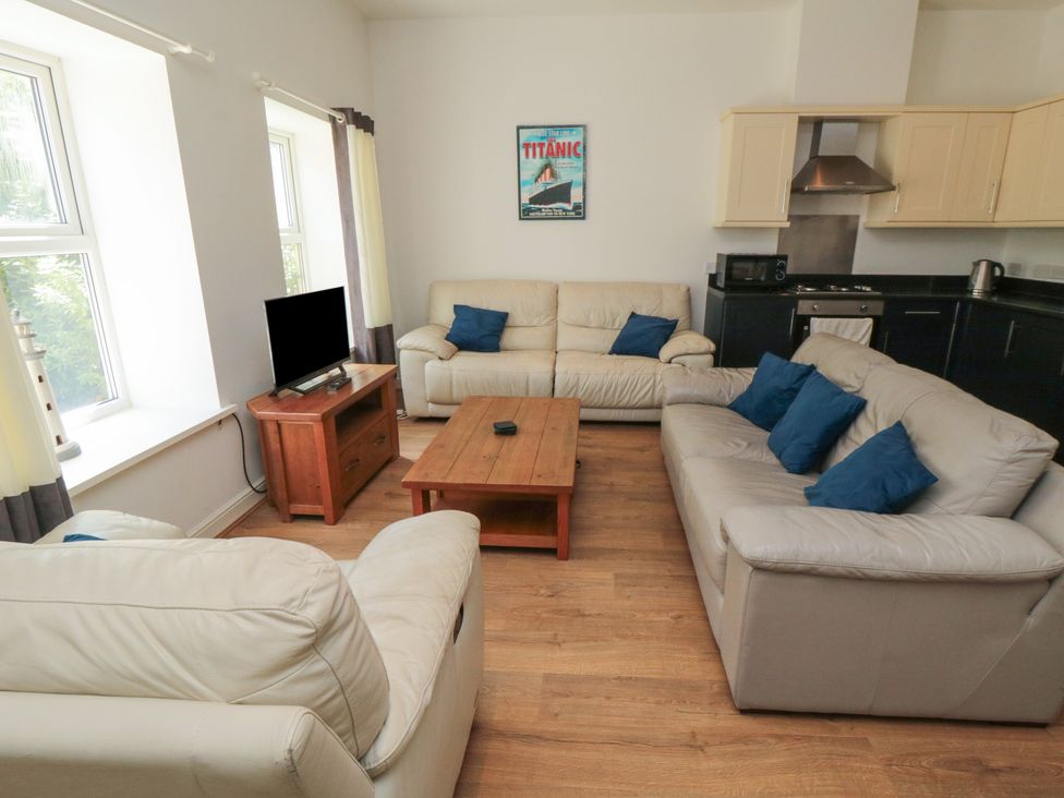 A living room with a coffee table and a television at 2 Londesborough Mews in Bridlington