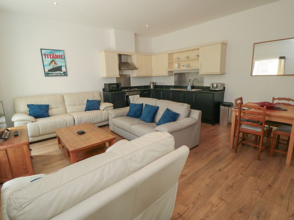 A living room with sofa and dining table at 2 Londesborough Mews in Bridlington