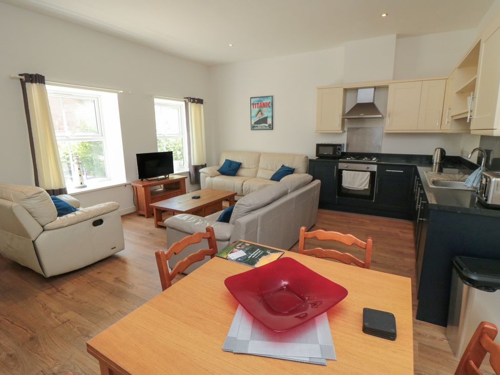 A living room with a sofa and table at 2 Londesborough Mews in Bridlington