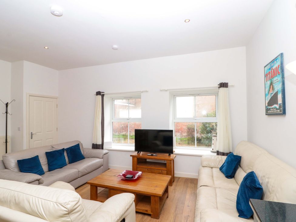 A living room with sofas and a television at Chestnut Cottage in Bridlington