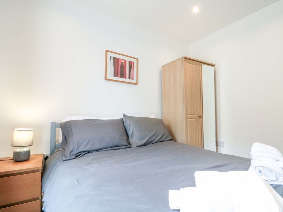 A bedroom with a bed and wardrobe at Chestnut Cottage in Bridlington