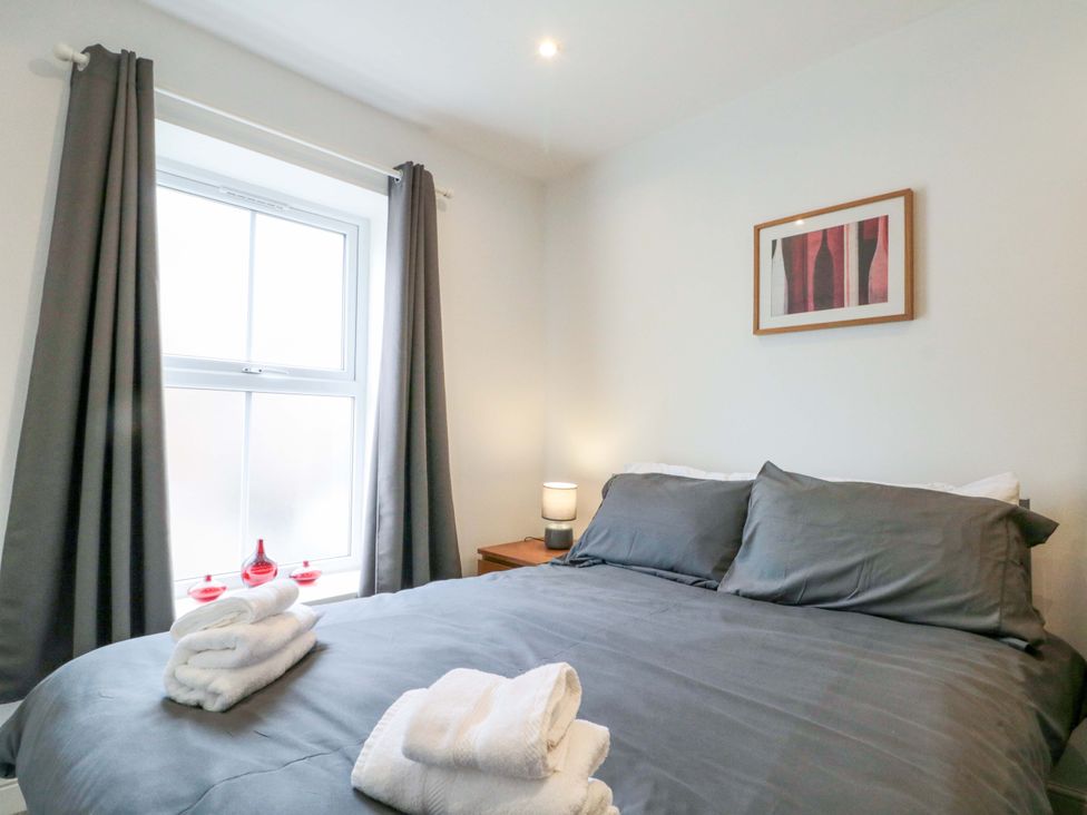 A bedroom with bed and lamp at Chestnut Cottage in Bridlington