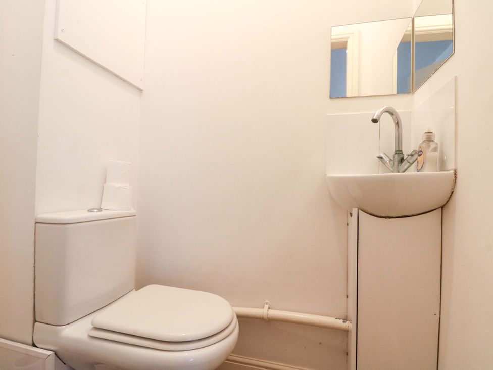 A bathroom with a toilet and sink at Chestnut Cottage in Bridlington