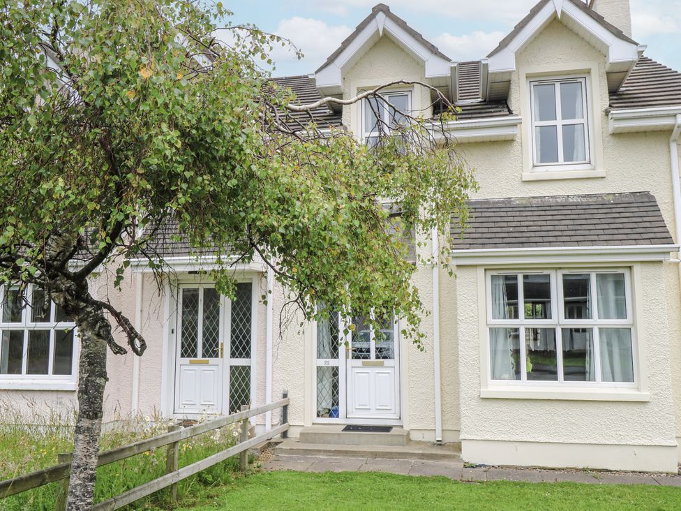 A house exterior with a tree and front door at 22 White Maples in Bundoran, County Donegal