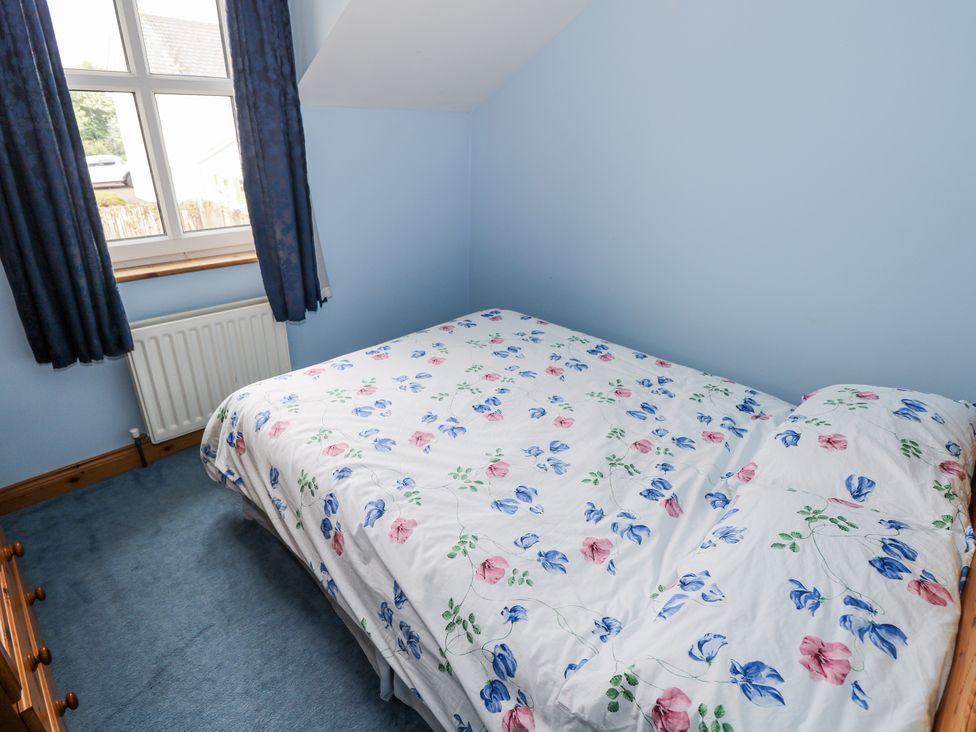 A bedroom with a bed and curtains at 22 White Maples, Bundoran, County Donegal
