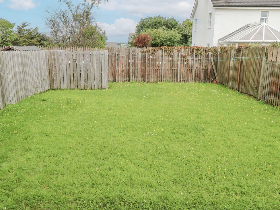 A garden with grass and a fence at 22 White Maples, Bundoran, County Donegal