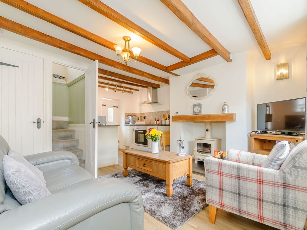 A living room with a sofa and coffee table at Chimes Cottage in Guisborough