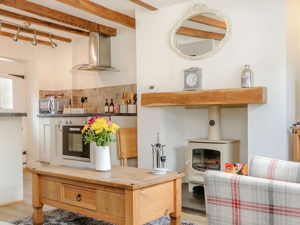 A kitchen with a table and flowers at Chimes Cottage in Guisborough