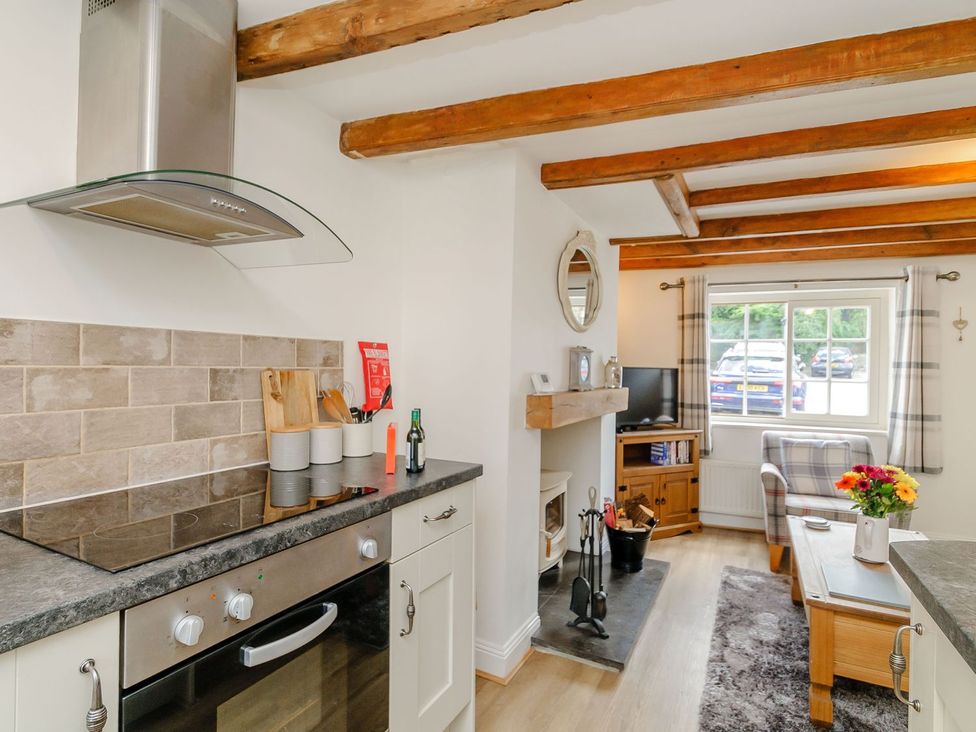 A kitchen with stove and television at Chimes Cottage Guisborough