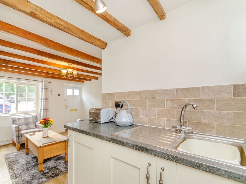 A kitchen with a sink and a kettle at Chimes Cottage in Guisborough