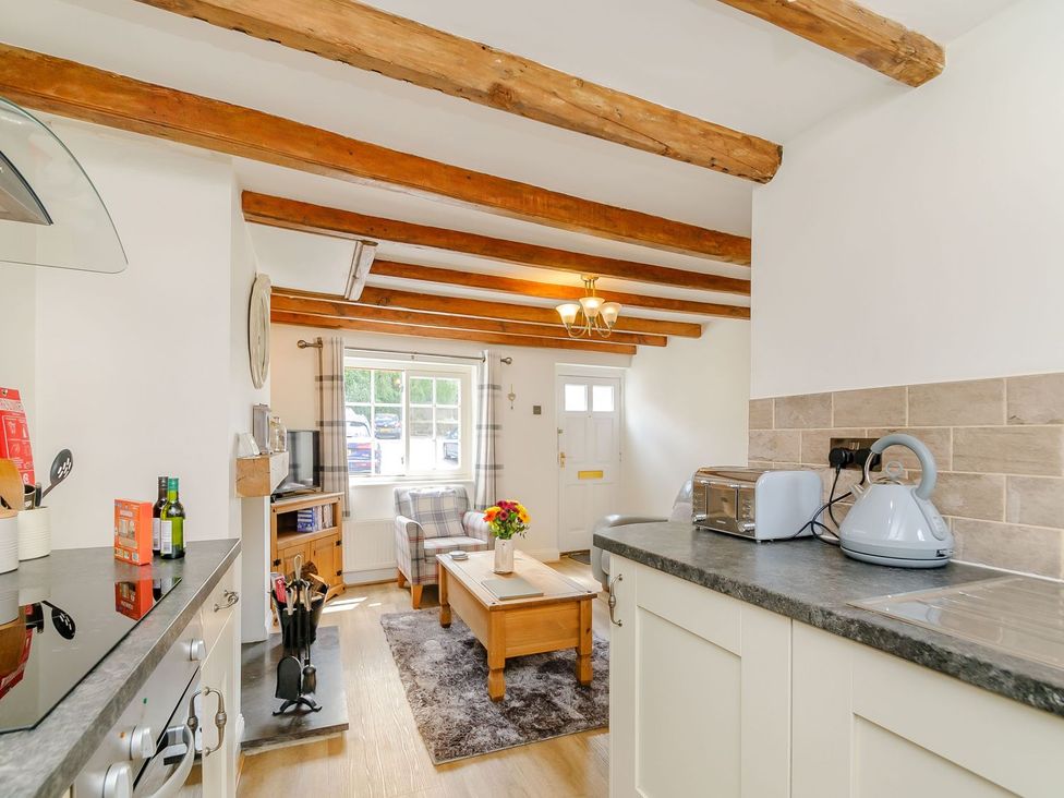 A kitchen with a table and chairs at Chimes Cottage in Guisborough