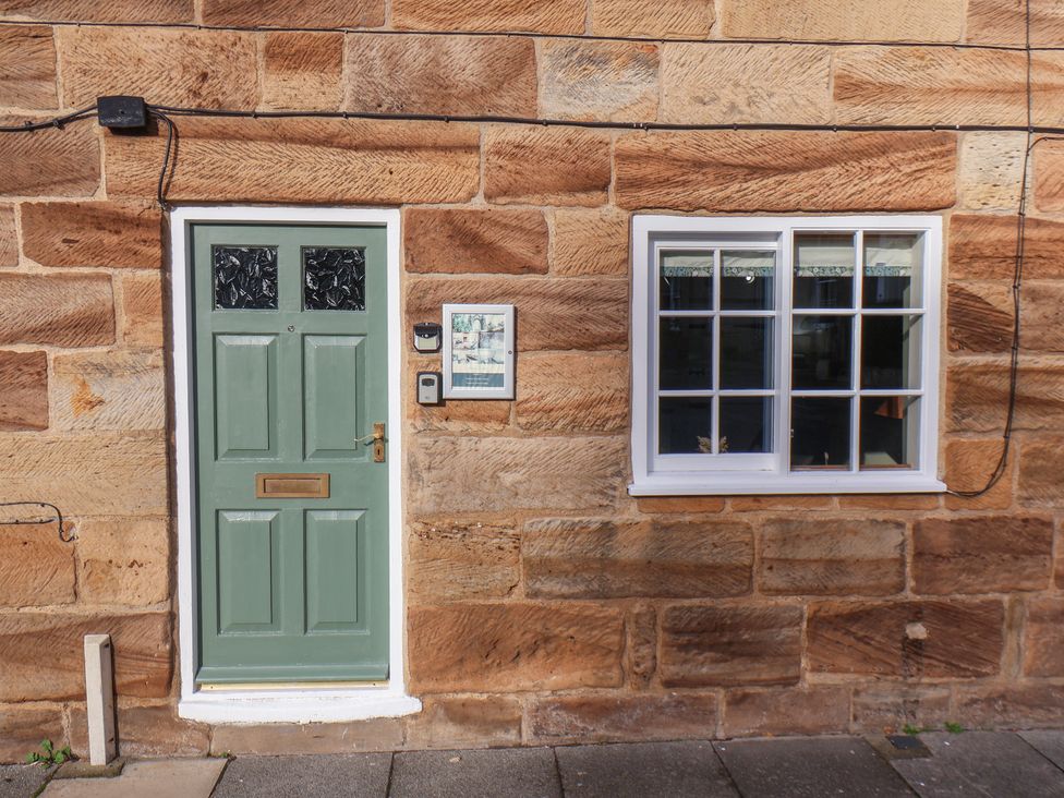 A door and window on a stone wall at Chimes Cottage in Guisborough