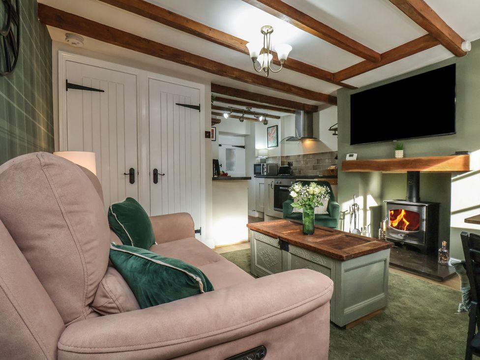 A living room with a sofa and coffee table at Chimes Cottage in Guisborough