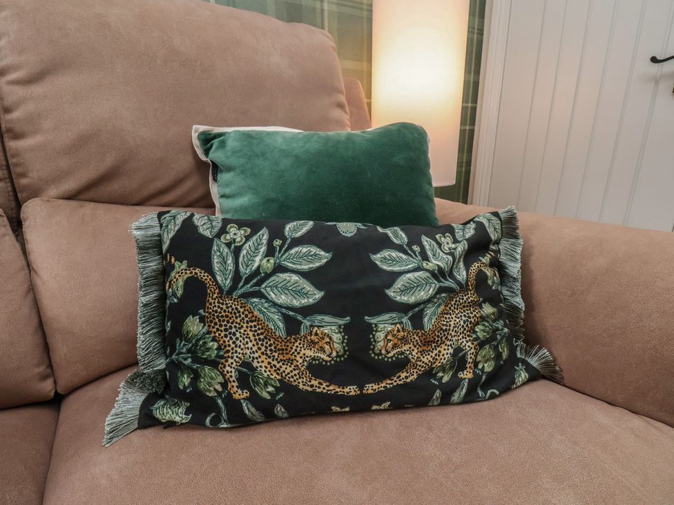 A pillow arrangement on a couch at Chimes Cottage in Guisborough